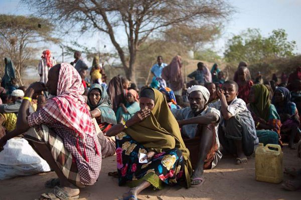 Newly arrived Somali refugees sit outside a transport centre in Dagahaley Refugee Camp near Dadaab in Kenya on July 22, 2011. President Uhuru Kenyatta will on Friday meet members of the United Nations Security Council in Nairobi to discuss the impending repatriation of refugees.