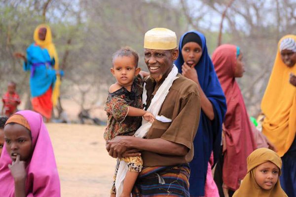 Refugees wait to undergo a documentation process at Dadaab airstrip on June 16, 2016 as they prepare to be voluntary repatriated. 