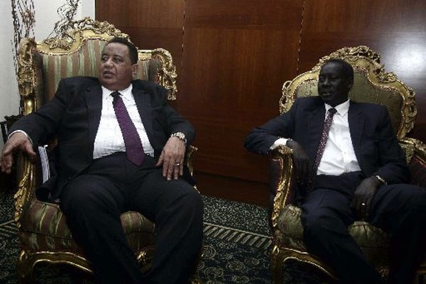 Sudanese Foreign Minister Ibrahim Ghandour (left) meets with his South Sudanese counterpart Deng Alor in Khartoum on June 5, 2016. The two countries signed a peace deal.