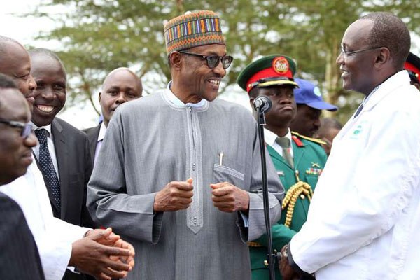 Nigerian President Muhammadu Buhari (centre) has a word with Mr Muhoho Kenyatta (right) at a Brookside Dairy plant in Ruiru, Nairobi, January 28, 2016.