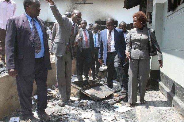 Education Cabinet Secretary Fred Matiang'i (second right) and other Education ministry officials when they toured Itierio Boys High School in Kisii County, Monday, June 27, 2016, after seven burnt dormitories were burnt by rioting students the previous day.