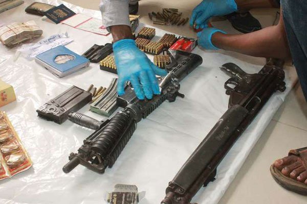 Security agents display a cache of arms and ammunition, including G3 and M4 rifles and 345 bullets, 11 phones and a laptop, among other items recovered in a house in Majengo, Mombasa County, on Jan 5, 2015. Police officers shot dead five suspected robbers in Kiambu on July 22, 2016.