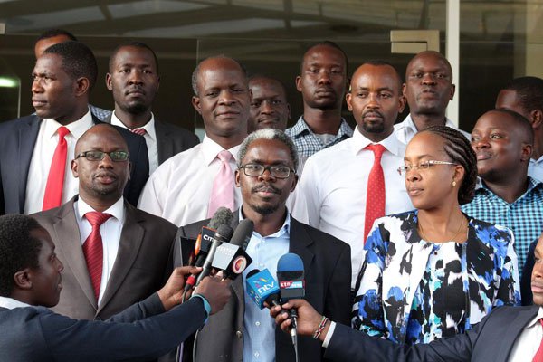 Kenya Medical Association secretary general Lukoye Atwoli (centre) chairperson Jacqueline Kitulu (right) dental association chairman Wetende Andrew (left) and other officials address a press conference in Nairobi on March 8, 2017.