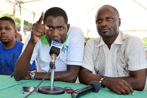 Kenya Medical Practitioners, Dentists and Pharmacists Union (KMPDU) Secretary-General Ouma Oluga (center), and other officials, addresses the media concerning the strike on December 31, 2016. They met with the president to discuss a deal.