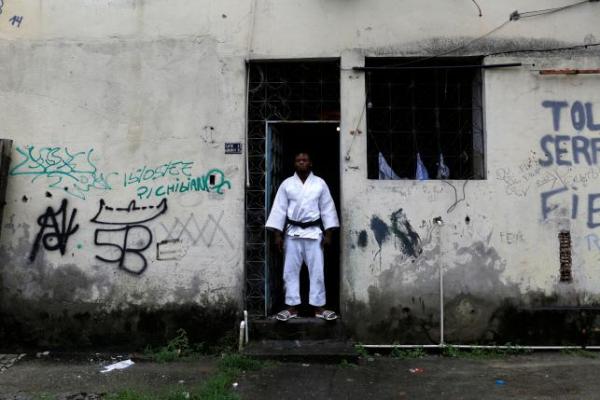Popole Misenga, a refugee from the Democratic Republic of Congo and a judo athlete, poses at the entrance of his home in a slum in Rio de Janeiro, Brazil, June 2, 2016