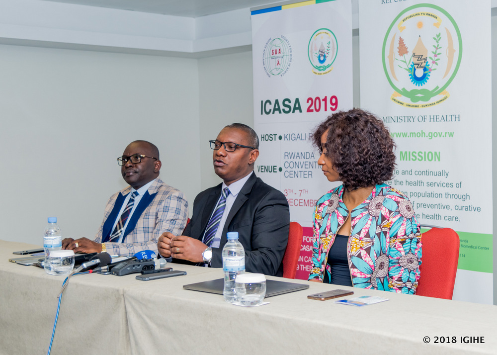 the State Minister of Public and Primary Healthcare in the Ministry of Health, Dr. Patrick Ndimubanzi (C) and Society for AIDs in Africa Coordinator, Luc Armand Bodea (L) in the press conference