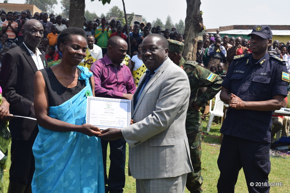 Governor Gatabazi hands a certificate to one of pact protectors