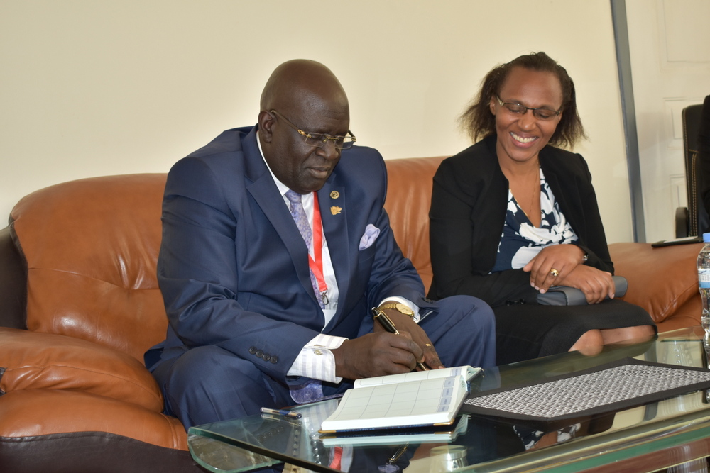 Prof. George Magoha Signs the visitors' book when he visited the campus. Looking on is the Deputy Vice Chancellor in charge of Academics, Dr. Mercilyn Kamande.