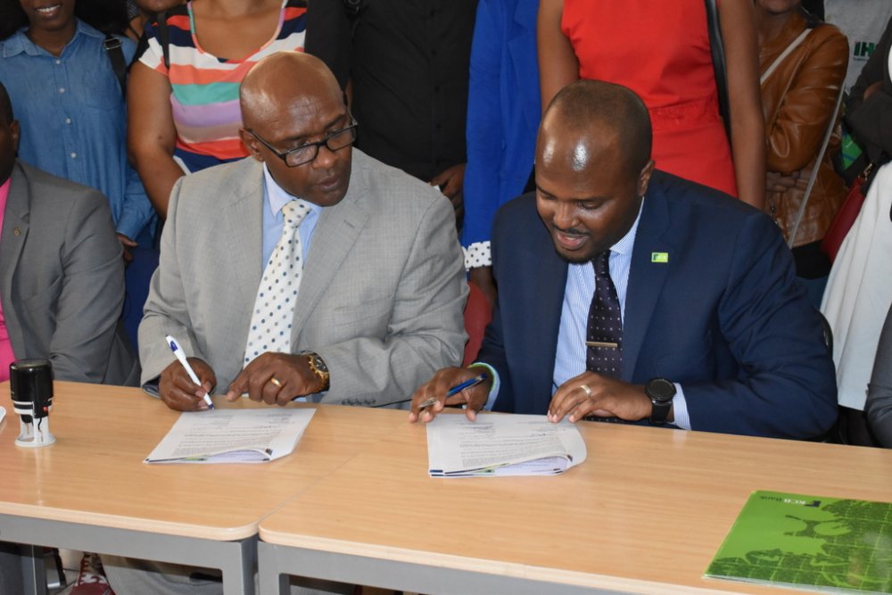 Head of Marketing and Corporate Communication at KCB Bank, Albert Akimanzi together with the Vice Chancellor of UoK, Prof. Abraham Waithima signing the agreement