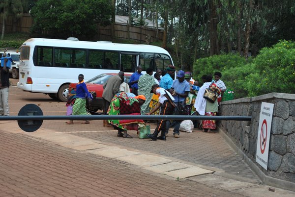 A security guard check on loads of caretakers visiting Butaro Hospital before admission to visit patients.