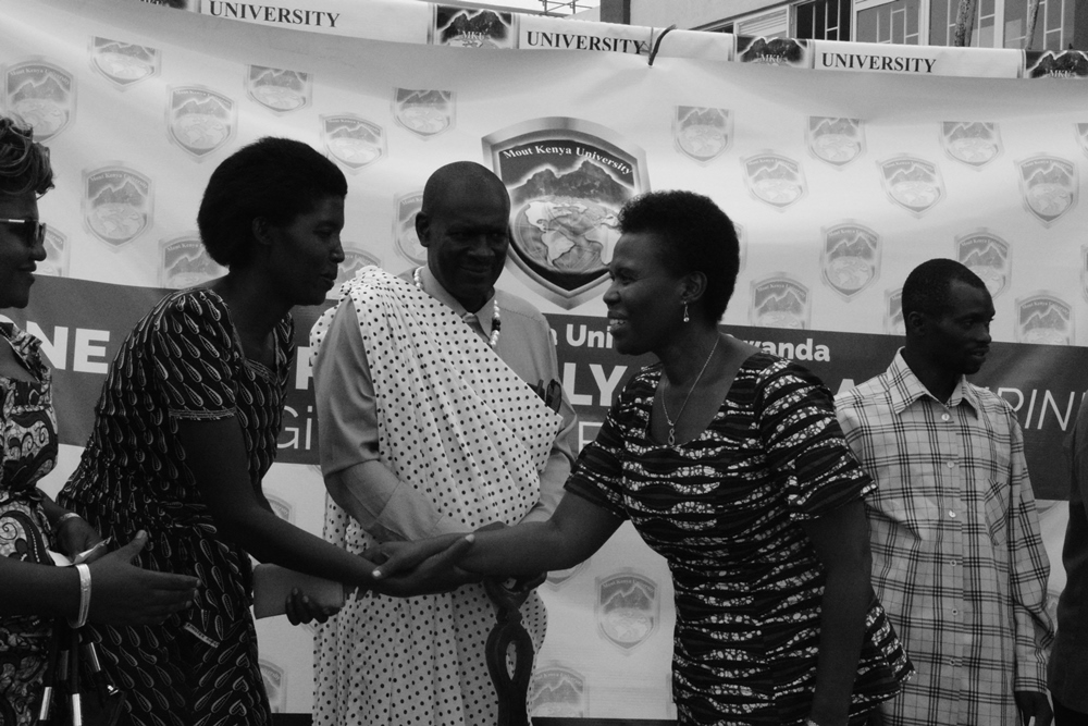 The Mayor of Kicukiro district Dr. Nyirahabimana Jeanne (right) appreciates one of the beneficiaries during the ceremony as the Vice Chancellor of MKUR, Prof Edwin Odhuno looks on.