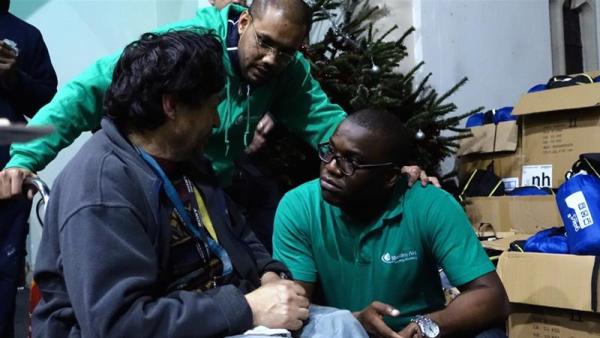 Muslim Aid charity workers hand out winter packs at a London church