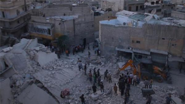 Men inspect damage after an airstrike on Aleppo''s rebel held al-Hallak neighbourhood