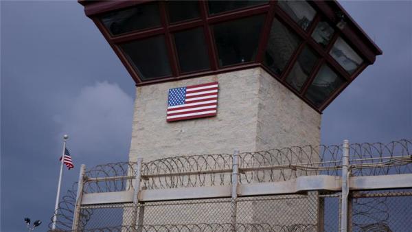 The United States flag decorates the side of a guard tower at Guantanamo Camp VI in Cuba