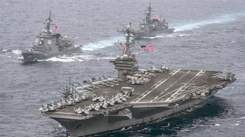 The USS Carl Vinson supercarrier cruises towards the Korean Peninsula escorted by Japanese destroyers