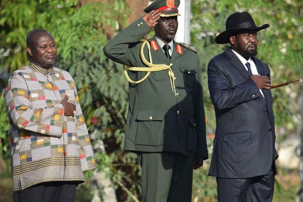 Former rebel leader Riek Machar (left) and President Salva Kiir listen to the national anthem during the swearing-in of Dr Machar as the new South Sudan first vice-president in Juba April 26, 2016.