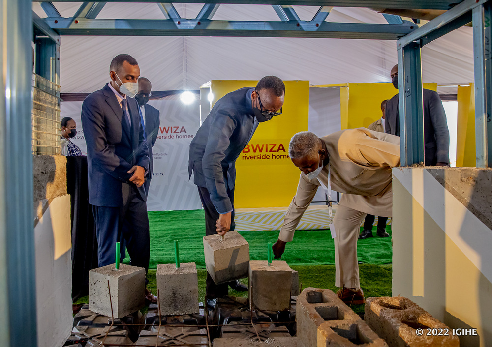 The chairman and the founder of ADHI, Soleman Idd showing some of materials used to build eco-friendly housing units to President Paul Kagame (in the middle) as other participants of the event look on.  