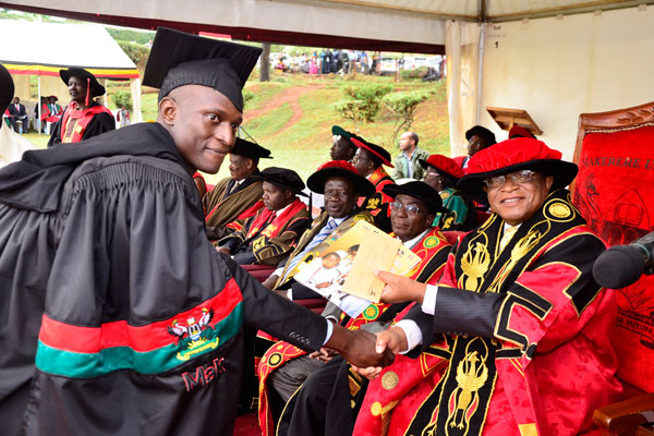 Awarded. Makerere University Chancellor, Dr Ezra Suruma (right), hands over a certificate to Mr Rodgers Mukalele (left), the most outstanding student in sciences during the 67th graduation ceremony last month.