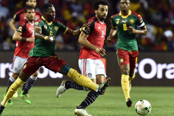 Cameroon's defender Ambroise Oyongo (left) vies for the ball against Egypt's forward Mohamed Salah during the 2017 Africa Cup of Nations final football match between Egypt and Cameroon at the Stade de l'Amitie Sino-Gabonaise in Libreville on February 5, 2017. Cameroon has won the Cup.