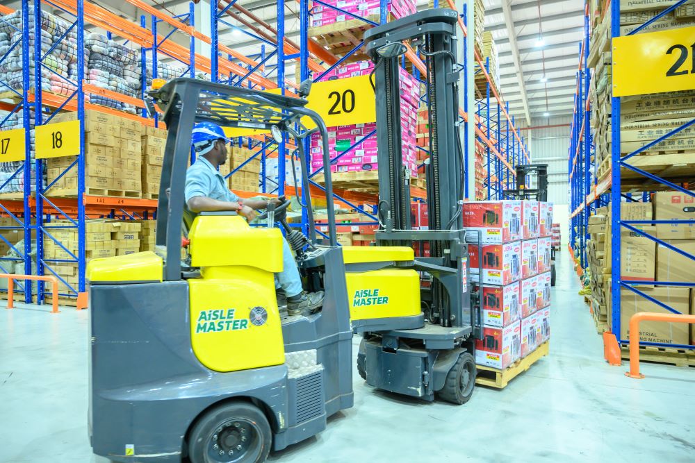 An employee moving cargo in the warehouse