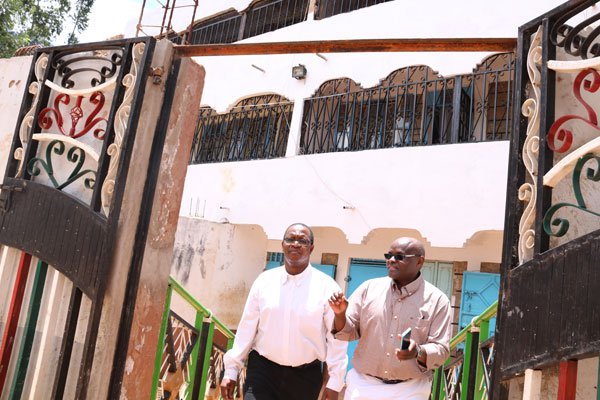 Interior PS Karanja Kibicho and Interior Ministry spokesman, Mwenda Njoka leave a home suspected to be an illicit brewing haven on March 3, after they were unable to access some areas despite strong stench of liquor emanating there.