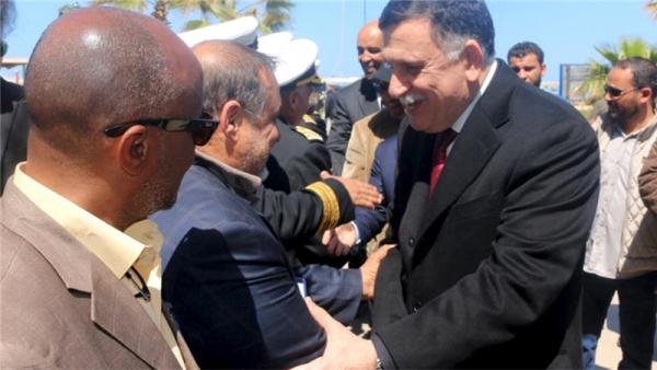 Fayez al-Sarraj is greeted upon arrival in the Libyan capital of Tripoli