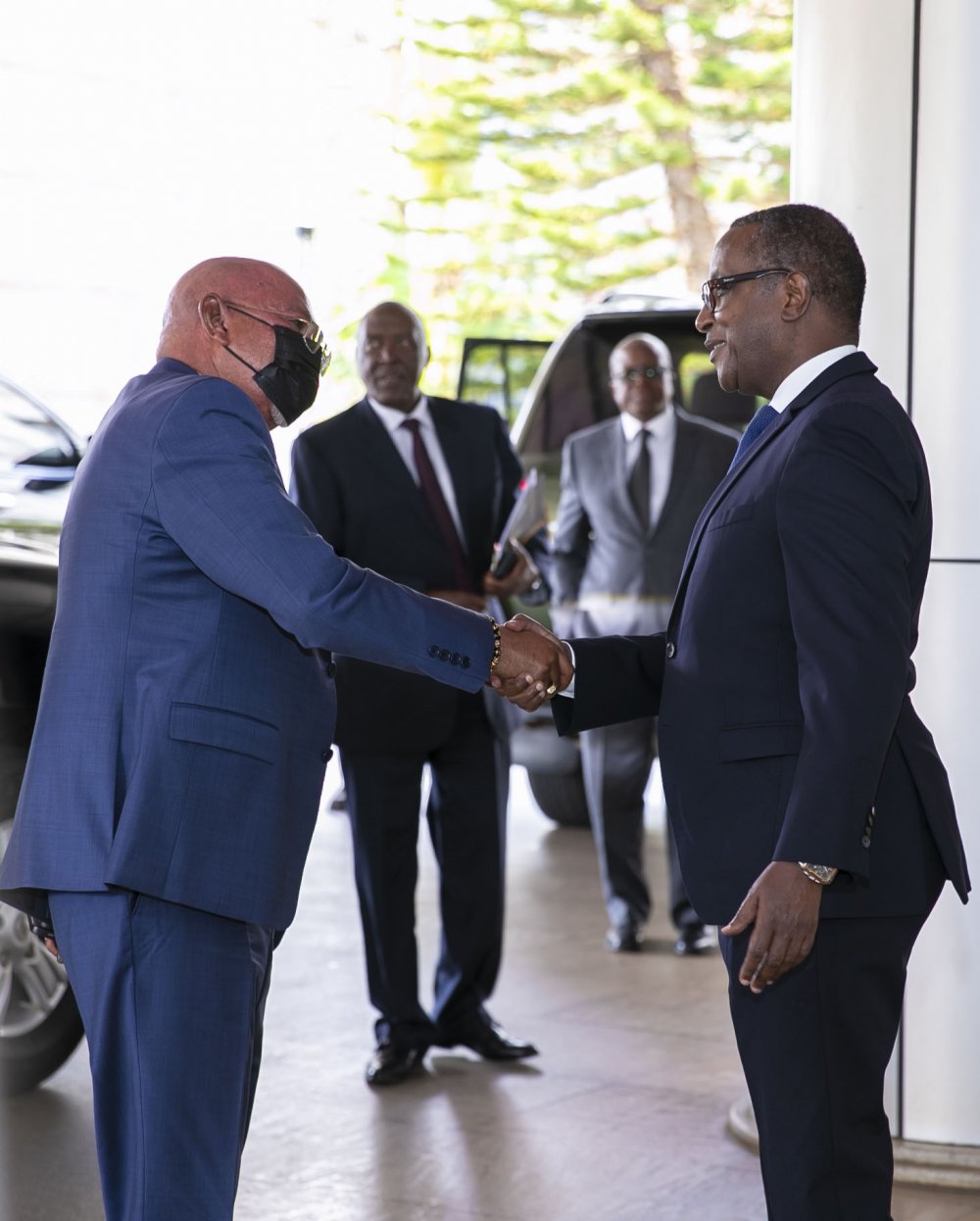 Minister Biruta (right) exchanging greetings with his counterpart of Uganda. 