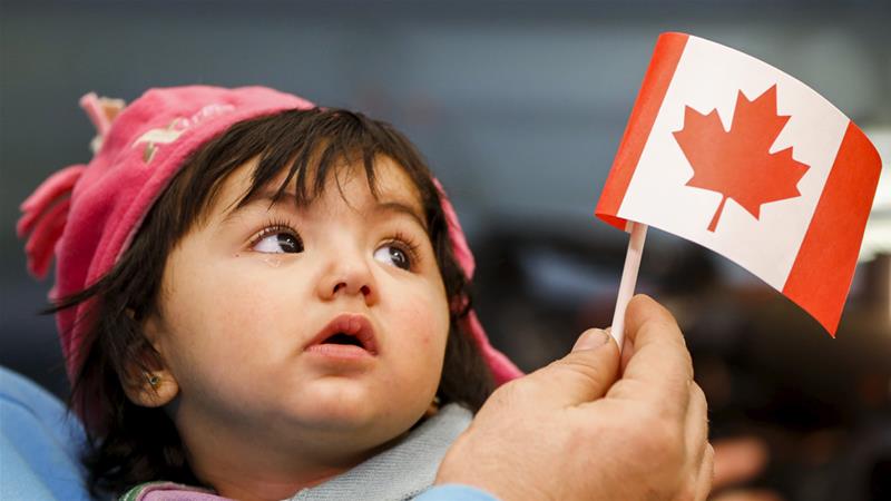 A Syrian refugee with her father arrives at Pearson Toronto International Airport