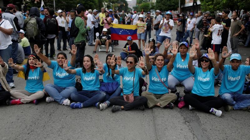 Opposition supporters block an avenue during an anti-government rally in Caracas