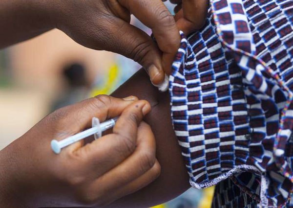 A woman receives a vaccination. The World Health Organisation has warned that the yellow fever outbreak in Angola poses a "threat to entire world".