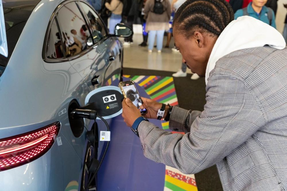 A visitor takes photos of an electric vehicle of BYD from China during the Festival of Motoring in Johannesburg, South Africa, Aug. 30, 2024. This event is held here from Aug. 30 to Sept. 1. (Xinhua/Zhang Yudong)