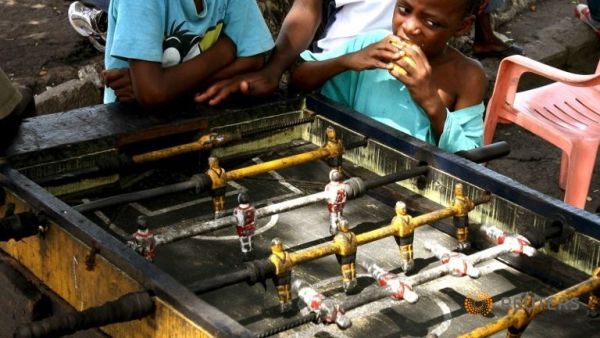 A boy watches table soccer as children play in the Democratic Republic of Congo's capital Kinshasa, in November 12, 2006