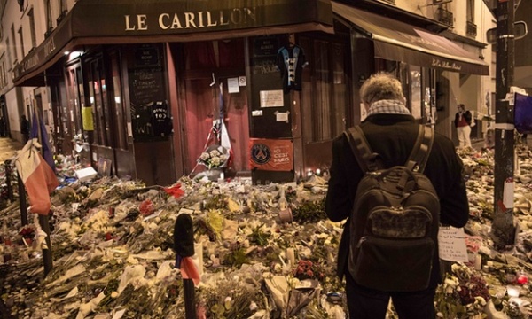 Flowers, candles and messages pile up outside Le Carillon restaurant in Paris, site of a terrorist attack on 13 November