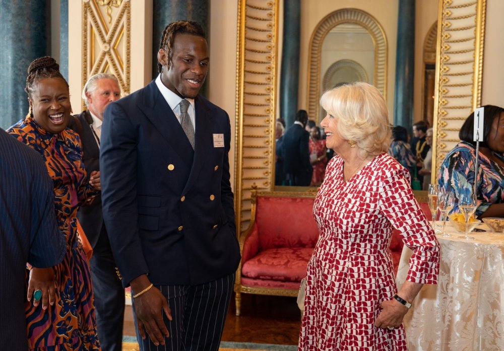 The Duchess of Cornwall, Camilla interacting with a participant of the event. 