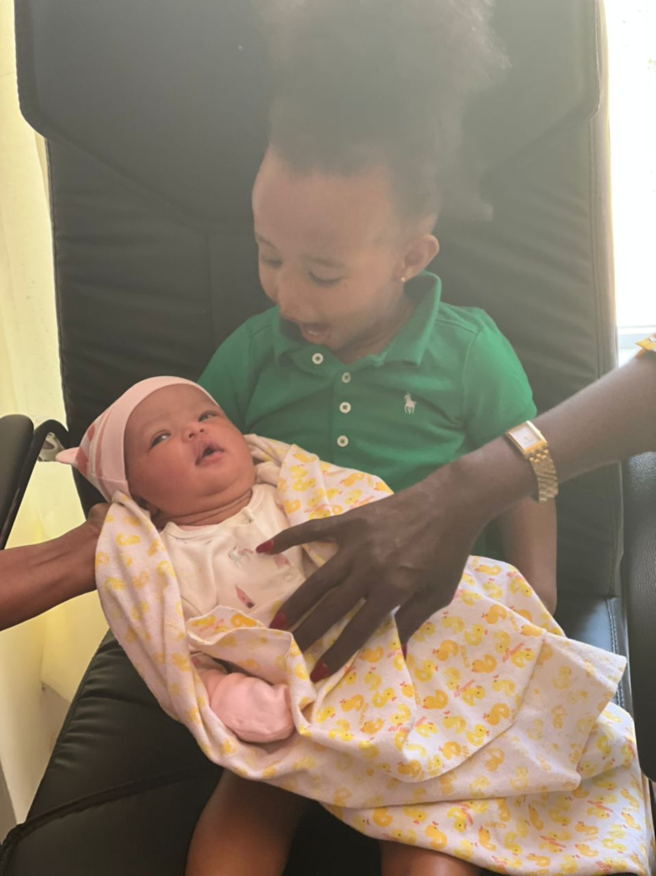 President Kagame has shared a photograph of his granddaughter holding the newly born baby. 