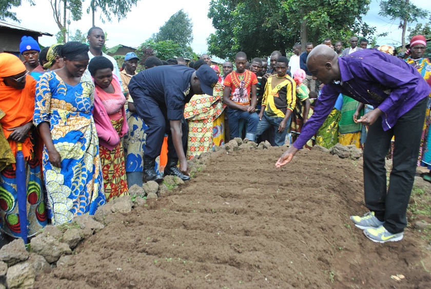 Minister Francis Kaboneka cultivating in one of the kitchen gardens - Akarima k'igikoni prepared in Musanze.