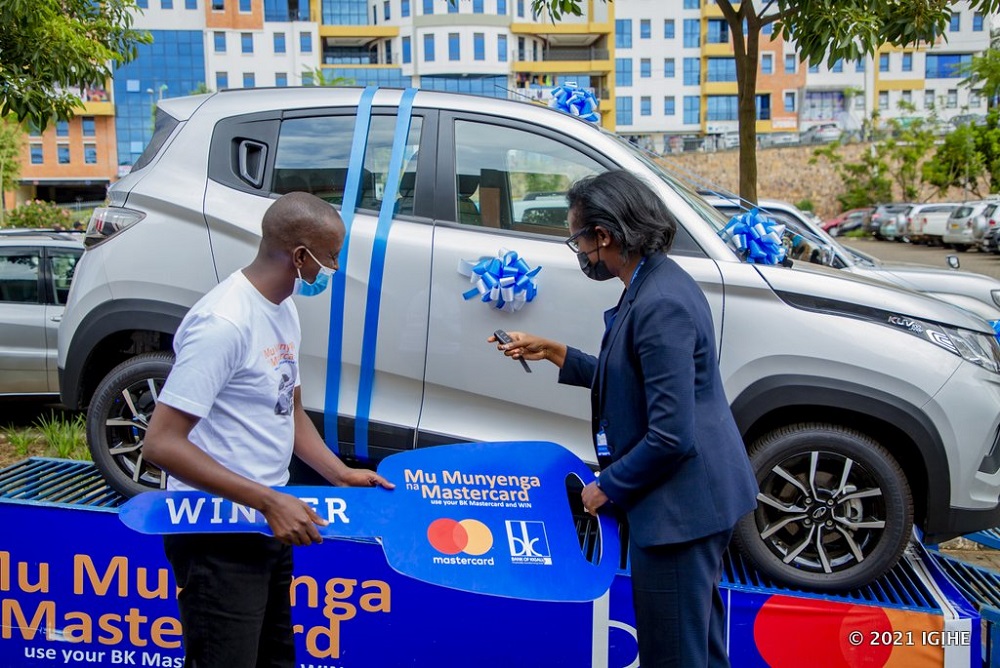 The CEO of BK , Dr. Diane Karusisi handing over the prize to the lucky winner, Gaga.