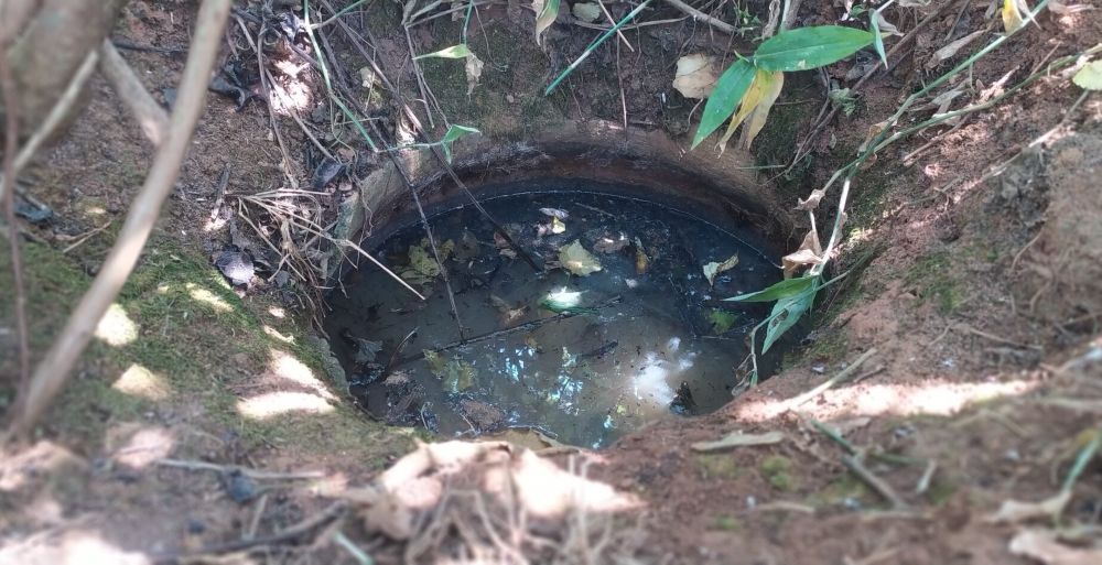 This clay pot, buried in the ground, represents a traditional weather forecasting site where rainfall patterns were once predicted.