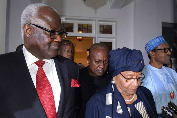 President of Liberia Ellen Johnson Sirleaf, flanked by the president of Sierra Leone Ernest Bai Koroma (left), the president of Nigeria Muhammadu Buhari (right) and the outgoing president of Ghana John Dramani Mahama walk in a hotel in Serekunda on December 13, 2016 after a meeting in a bid to persuade veteran leader Jammeh to accept his election defeat and hand over power.