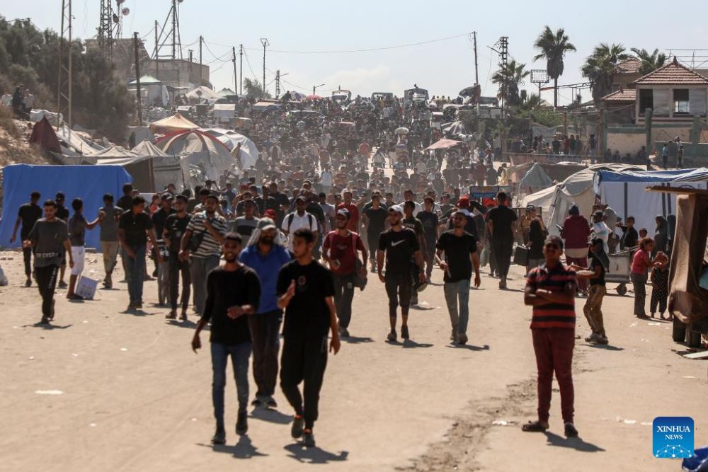Palestinians walk on road returning to Gaza City, near the central Gaza Strip, Oct. 10, 2025. Displaced Palestinians have begun returning from the southern part of the Gaza Strip to the north after the Israeli army announced that civilians are permitted to move through the coastal Rashid Road and Salah al-Din Road, local sources said on Friday.