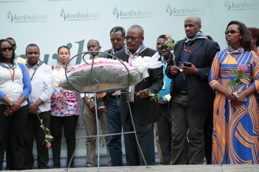 George Gitau laying wreaths on mass graves at Kigali Genocide Memorial