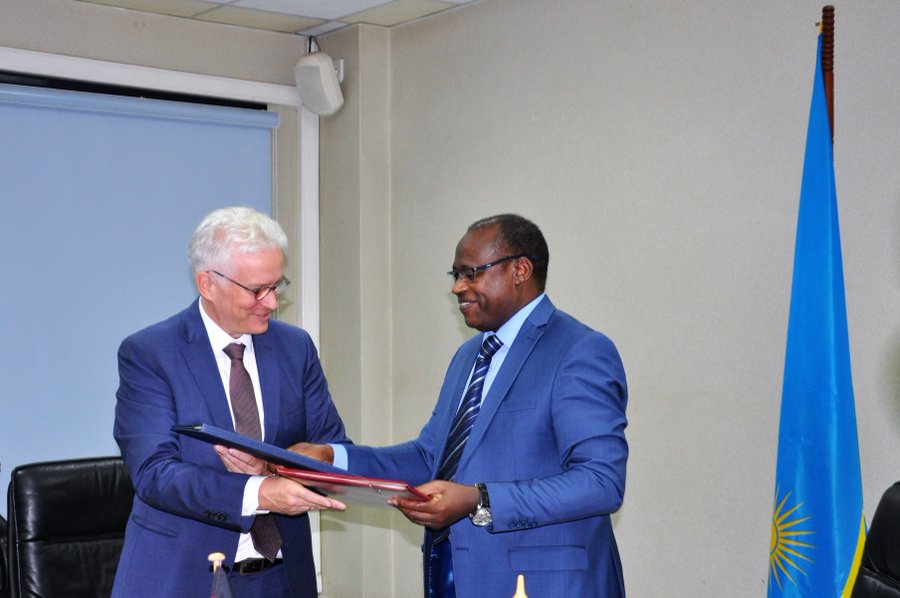 German envoy Dr. Thomas Kurz (L) and Finance Minister Dr.Uzziel Ndagijimana exchange agreement papers