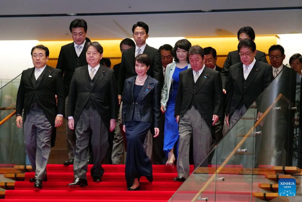 Japan's new Prime Minister Sanae Takaichi (front row, C) arrives for a photo session with members of her cabinet at the prime minister's office in Tokyo, Japan, Oct. 21, 2025. Sanae Takaichi, leader of Japan's ruling Liberal Democratic Party (LDP), was officially elected the country's prime minister on Tuesday after winning in both houses of parliament, becoming the country's first female leader.