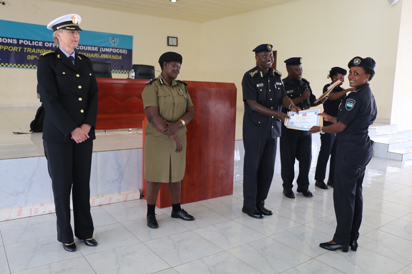 CP Vianney Nshimiyimana giving a certificate to a participant from Rwanda.