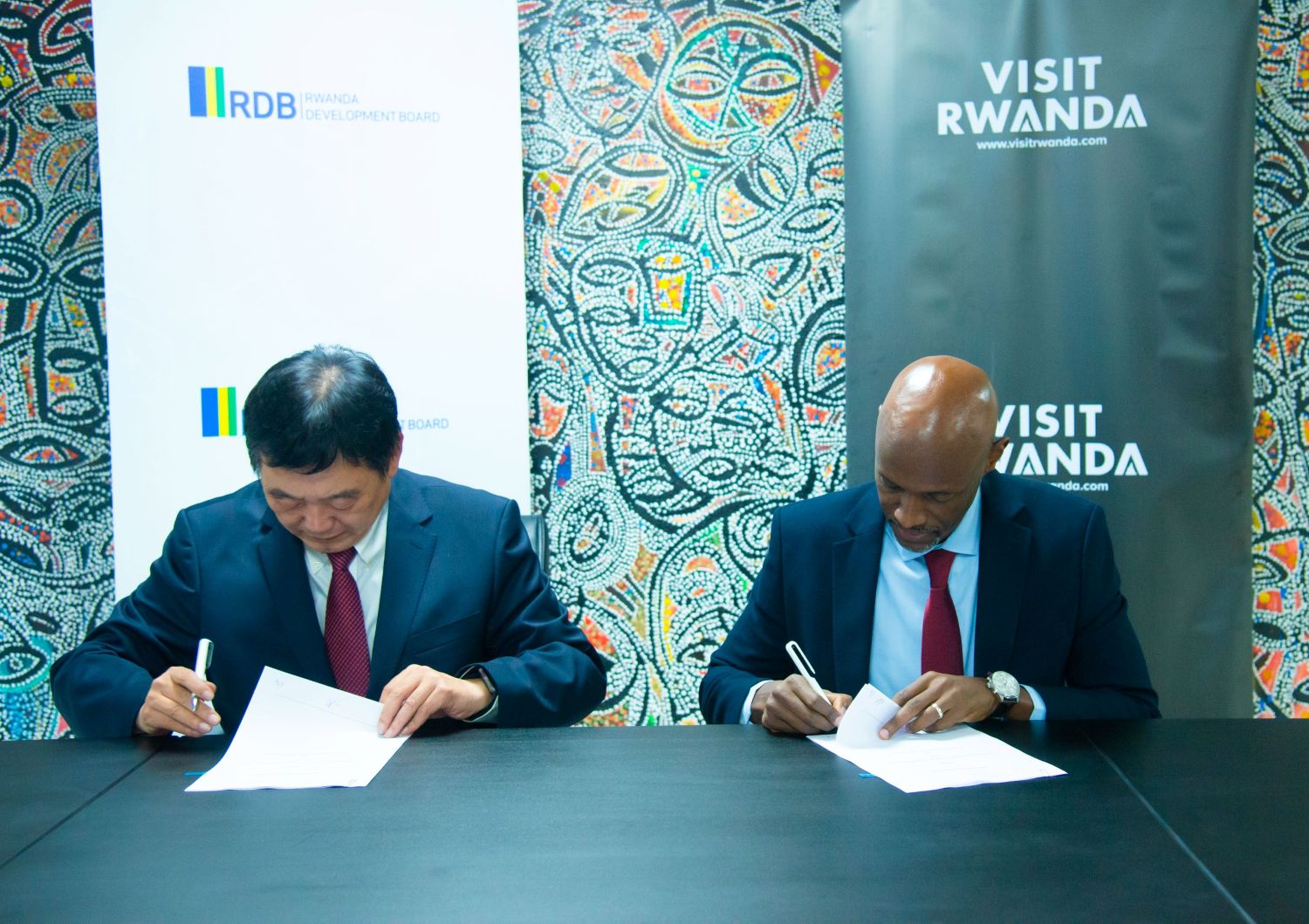 RDB Chief Executive Officer, Jean-Guy Afrika, and Chery Holding Group Chairperson, Xu Hui sign the agreement in Kigali on Saturday, April 12, 2025.