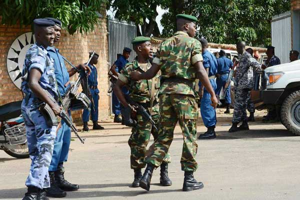 Burundian security officers secure a scene of a grenade attack on April 25, 2016 in Bujumbura. One person was killed after a grenade was hurled at a group of people near a bus station in Musaga, Bujumbura on June 15, 2017.