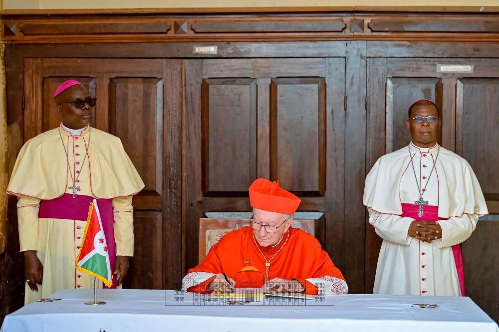 Cardinal Pietro Parolin, Vatican Secretary of State, signs the documents officially declaring Mugera Church a minor basilica.