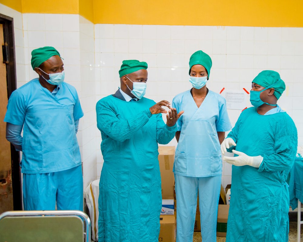 Olivier Nduhungirehe assisted along Iradukunda to cataract surgery at Nyamata District Hospital.