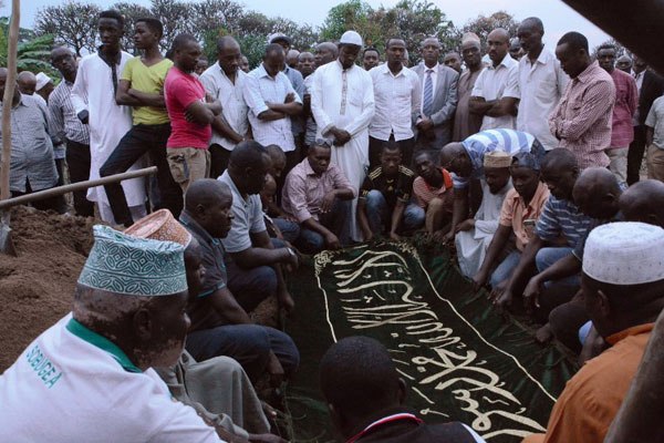People pray around the coffin of former Burundian minister Hafsa Mossi at her funeral in Bujumbura on July 13, 2016. France presented a draft resolution to the UN Security Council on Friday that calls for deploying up to 228 UN police to Burundi to monitor human rights and help quell violence in the African country.
