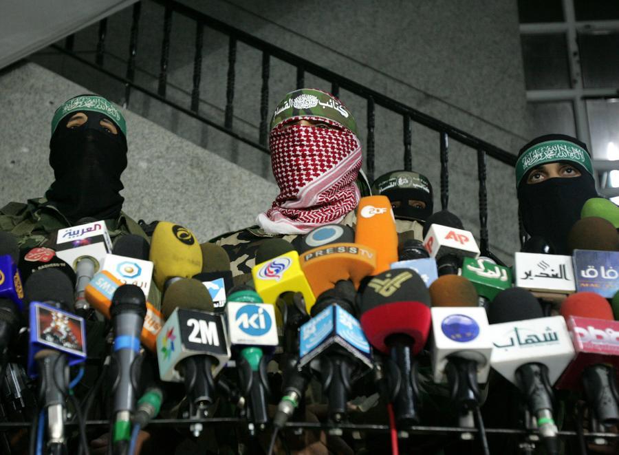 Abu Obeida (C), a spokesman for Hamas' armed wing, holds a press conference in Gaza City March 26, 2010.